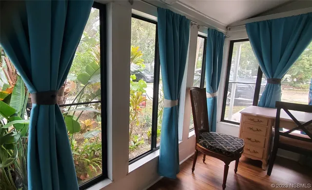 a view of a room with furniture and a window