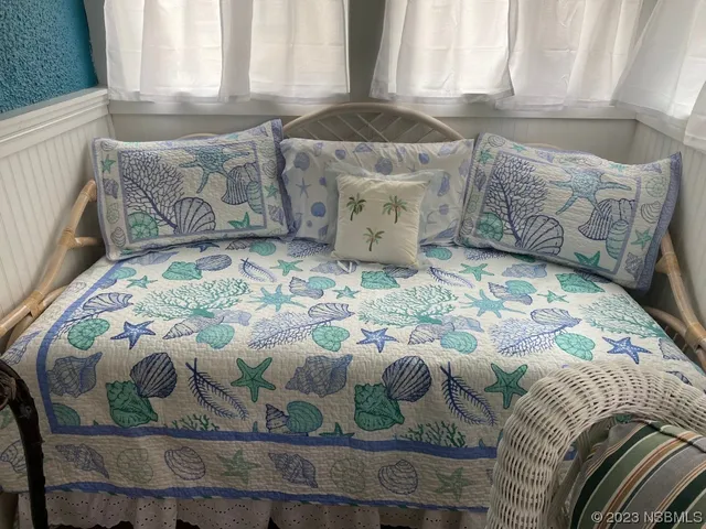 a bed sitting in a bedroom next to a window