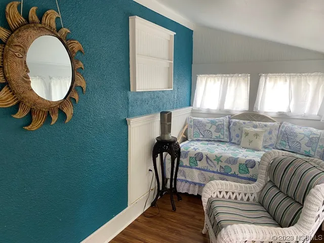a living room with furniture and a mirror