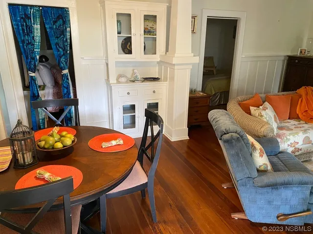 a view of a dining room with furniture and wooden floor