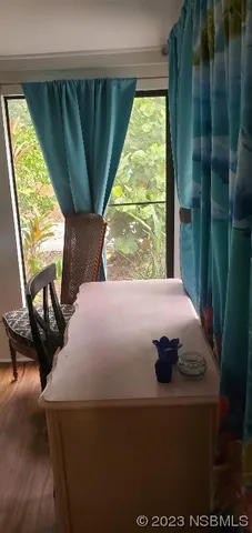 a bed sitting in a bedroom next to a window