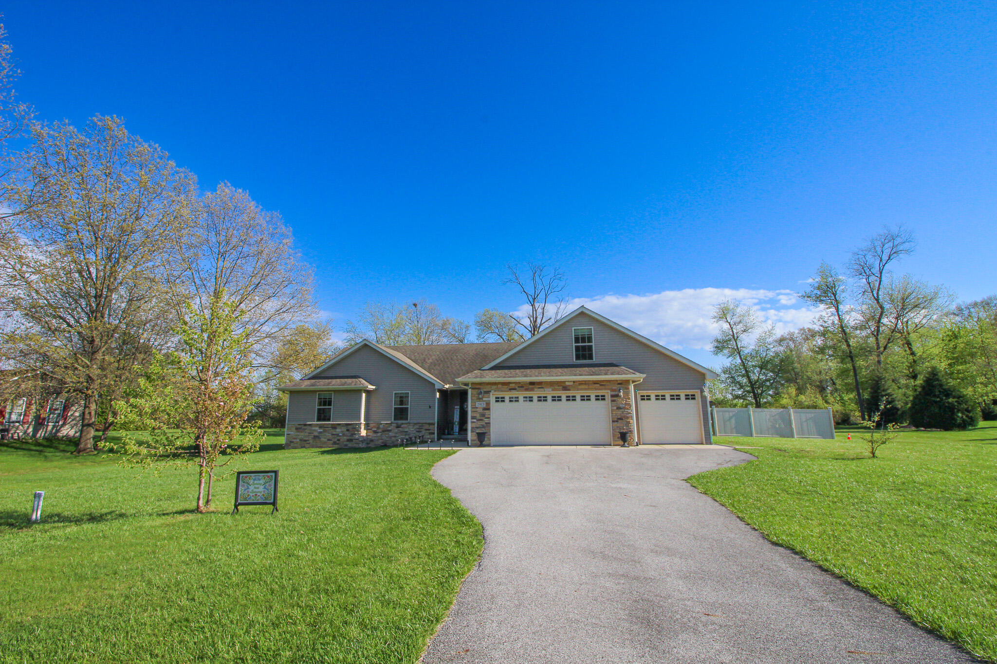 2913 Cardinal Drive Wheatfield, IN 46392 - Photo 2 of 34 a front view of a house with garden