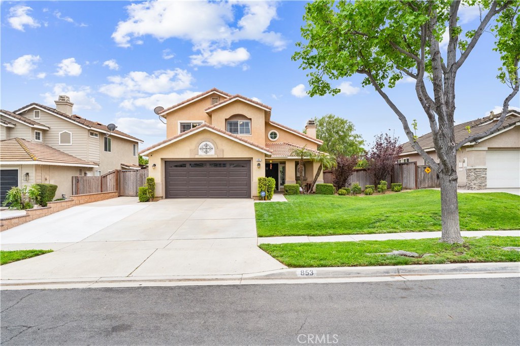 853 Cheyenne Road Corona, CA 92878 - Photo 2 of 8 a front view of a house with a yard and garage