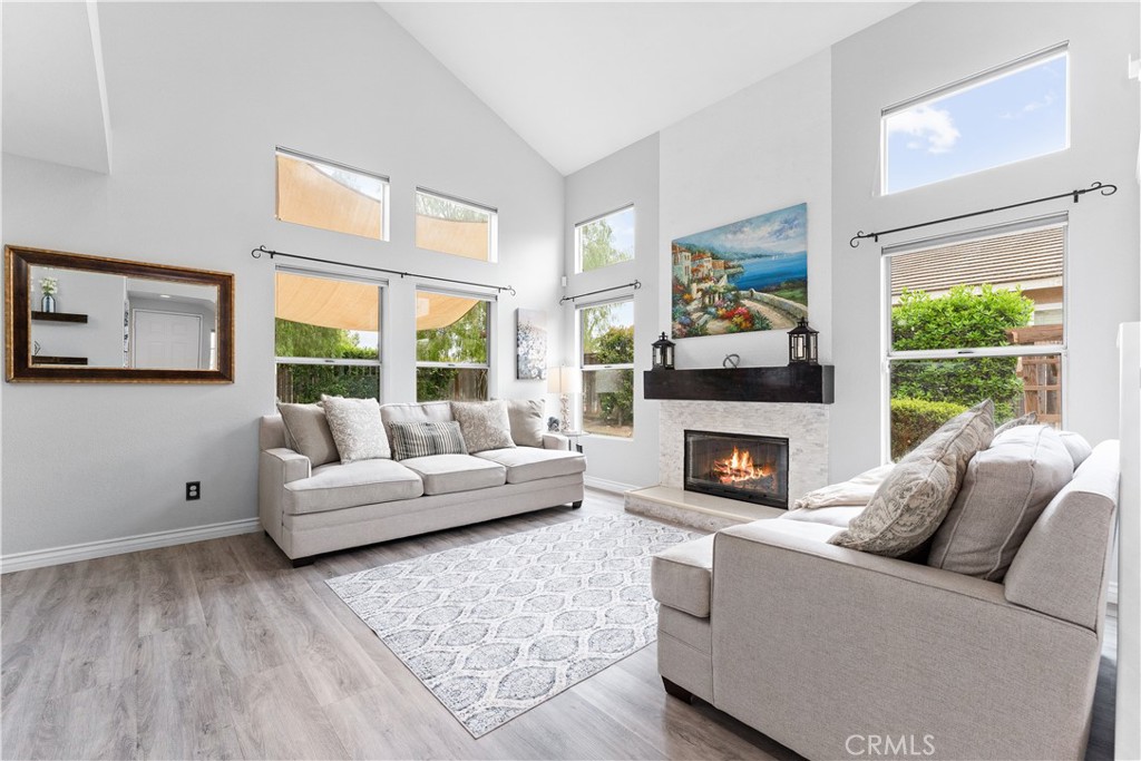 853 Cheyenne Road Corona, CA 92878 - Photo 4 of 8 a living room with furniture a fireplace and a large window