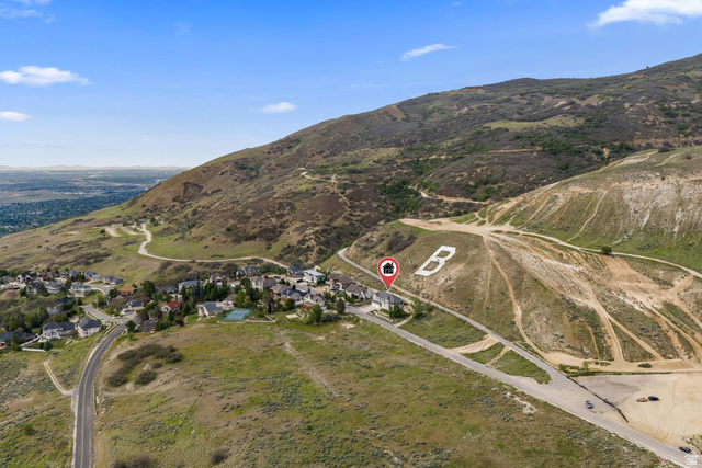 708 Eagle Rdg Drive Bountiful, UT 84010 - Photo 68 of 69 Aerial perspective showcasing a residential community nestled at the base of a verdant hillside