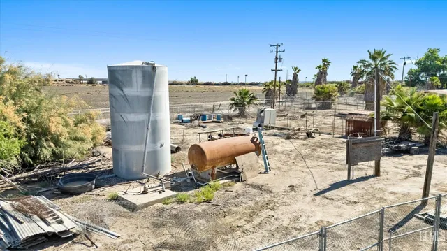 a view of a roof deck with couches and sky view