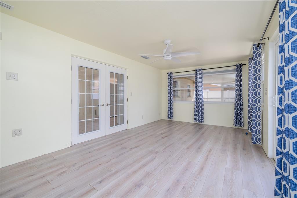 1016 Cherokee Ranch Road Holly Hill, FL 32117 - Photo 8 of 23 an empty room with wooden floor and windows