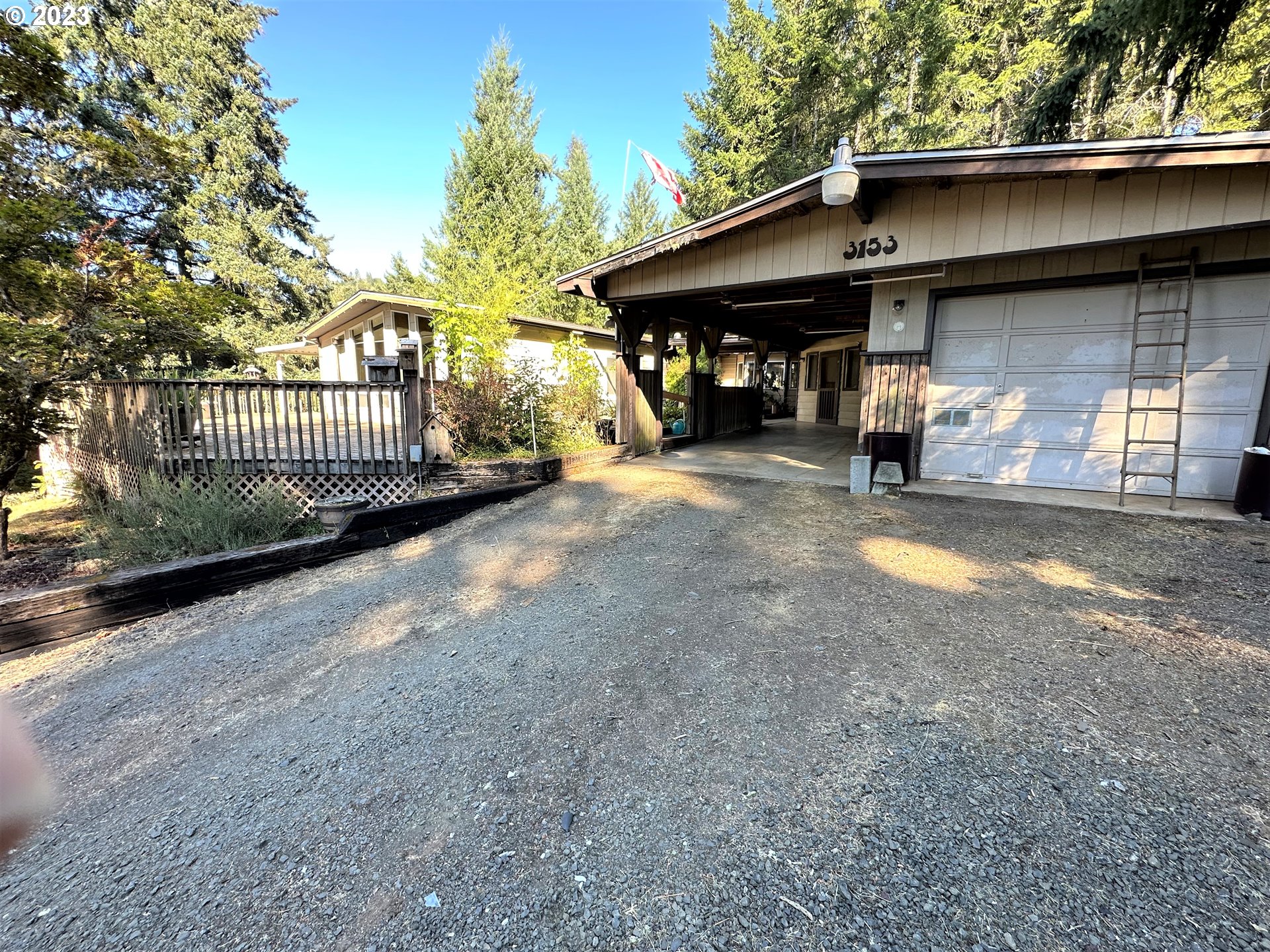 a view of a house with a patio and a yard