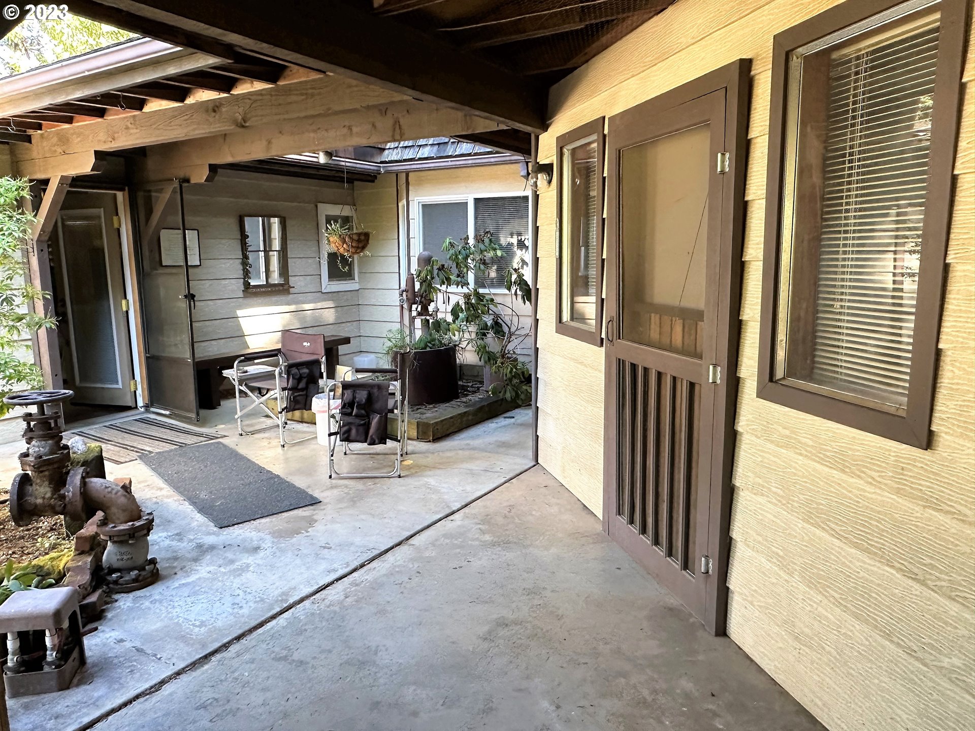 3153 Strickland Canyon Road Roseburg, OR 97471 - Photo 2 of 31 a view of a porch with dining table and chairs