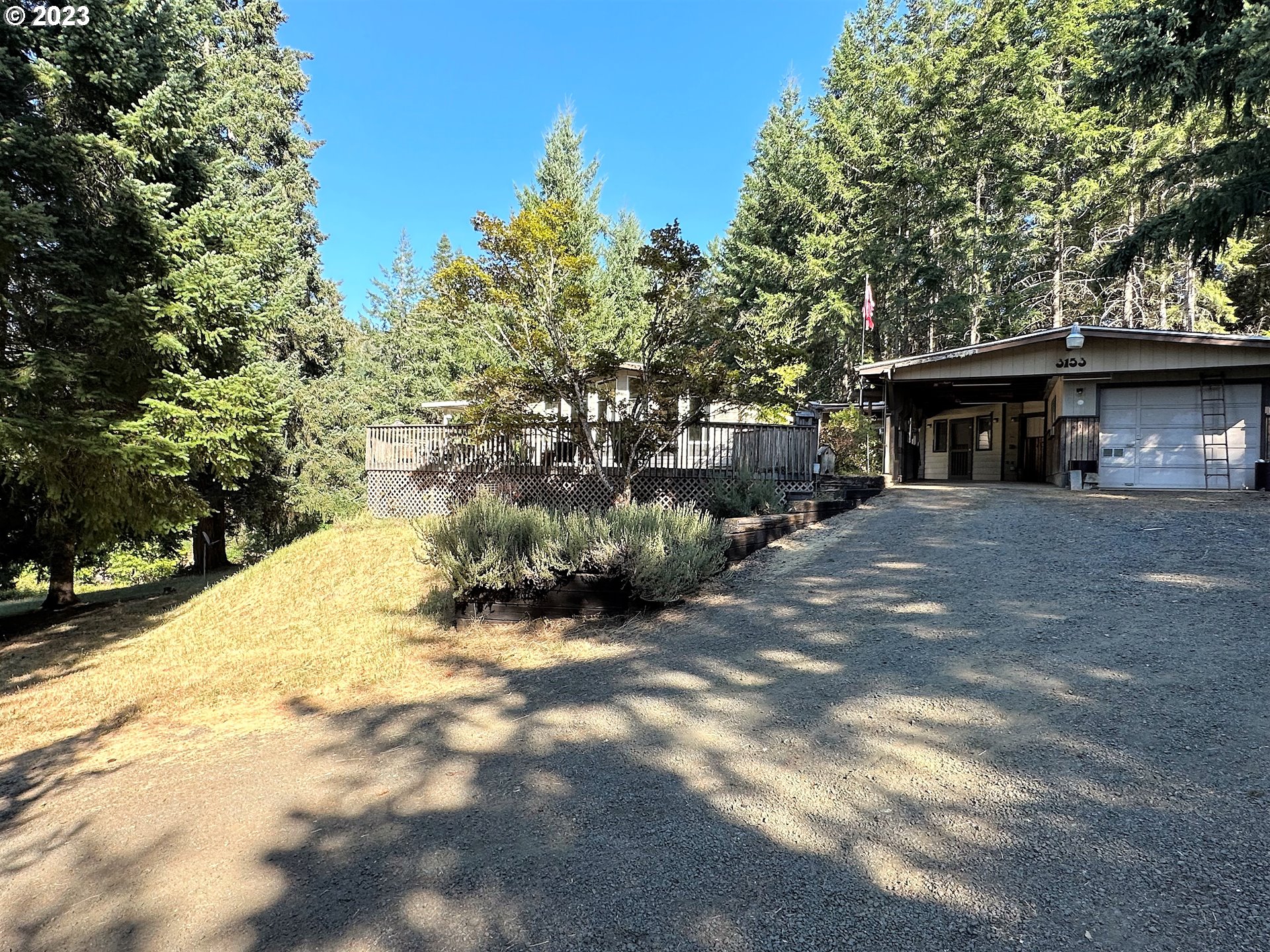3153 Strickland Canyon Road Roseburg, OR 97471 - Photo 30 of 31 a view of a house with a small yard and large tree