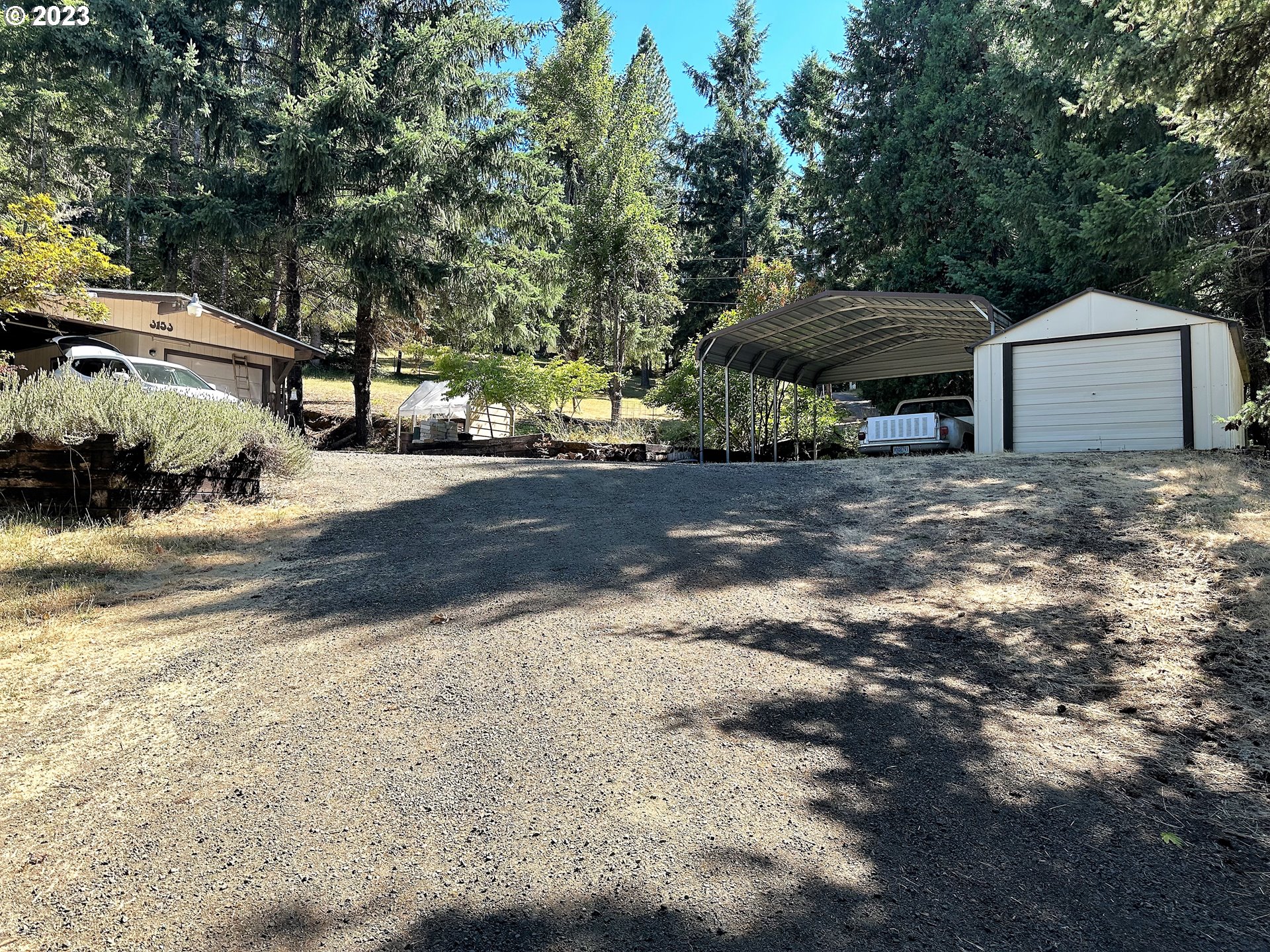 3153 Strickland Canyon Road Roseburg, OR 97471 - Photo 31 of 31 a backyard of a house with a yard and garage