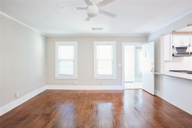 a kitchen with a sink cabinets and wooden floor