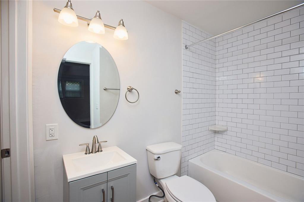 887 Myrtle Street Northeast Atlanta, GA 30309 - Photo 7 of 27 a bathroom with a toilet sink and mirror