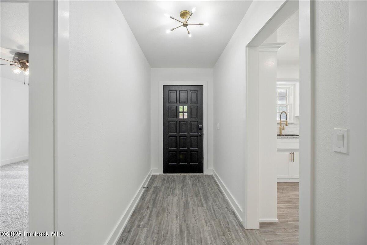 4214 64th Street Lubbock, TX 79413 - Photo 15 of 32 a view of a hallway with wooden floor and staircase