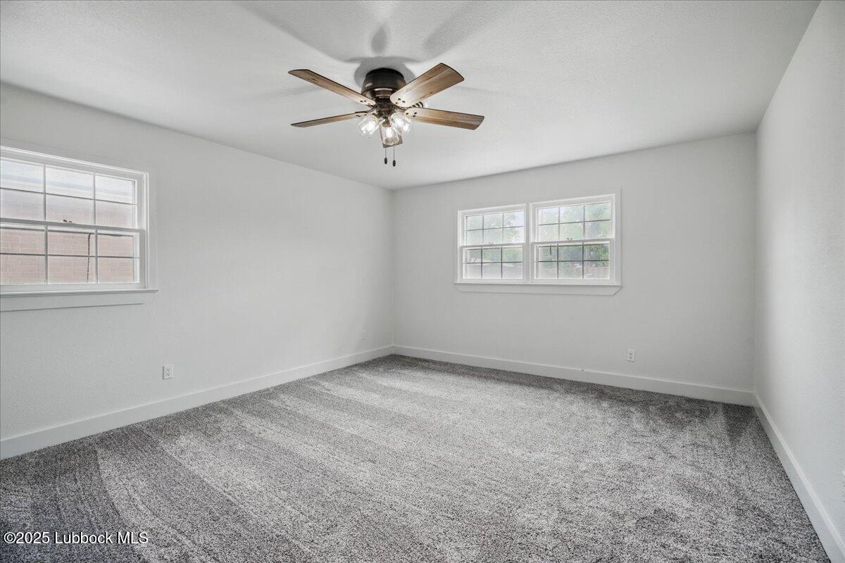 4214 64th Street Lubbock, TX 79413 - Photo 24 of 32 an empty room with windows and fan