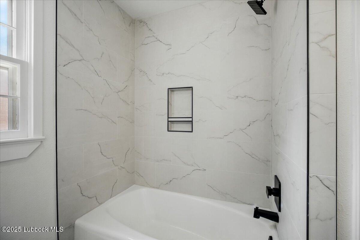 4214 64th Street Lubbock, TX 79413 - Photo 27 of 32 a bathroom with a bathtub