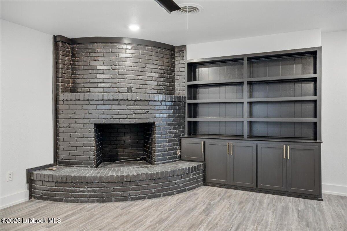 4214 64th Street Lubbock, TX 79413 - Photo 4 of 32 a living room with furniture and a fireplace