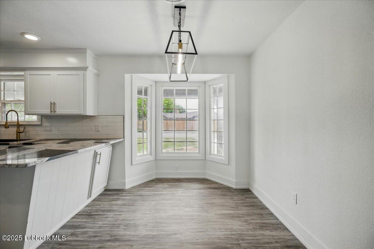4214 64th Street Lubbock, TX 79413 - Photo 6 of 32 a kitchen with stainless steel appliances granite countertop a stove a sink and a refrigerator