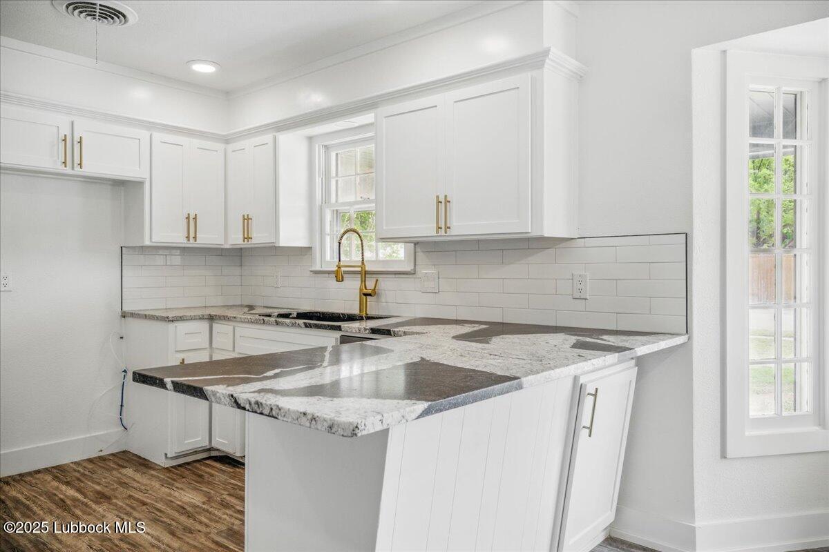 4214 64th Street Lubbock, TX 79413 - Photo 10 of 32 a kitchen that has a sink and a stove