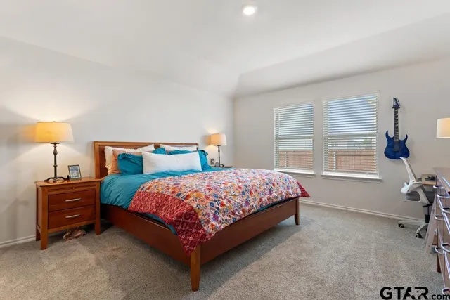 a bedroom with a bed and a table