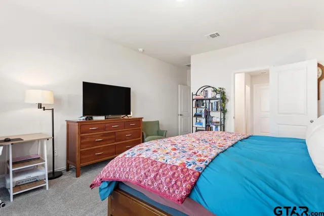 a bedroom with a bed and a flat screen tv