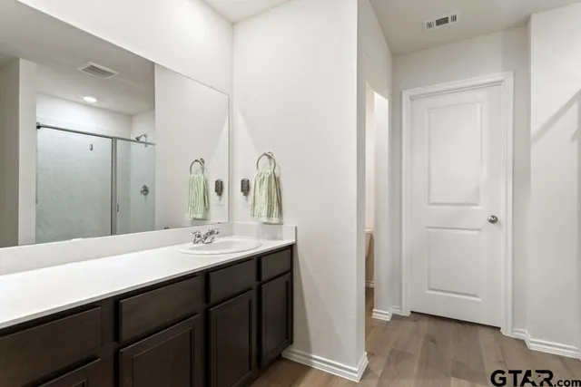 a bathroom with a double vanity sink and a mirror