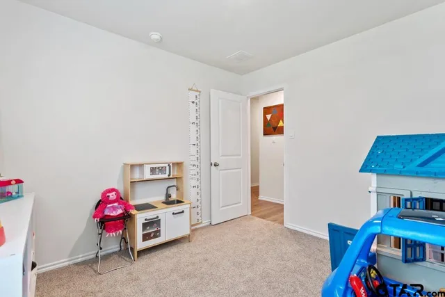 a bedroom with furniture and a lamp