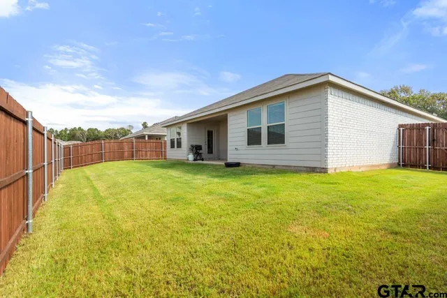 a view of a backyard of the house