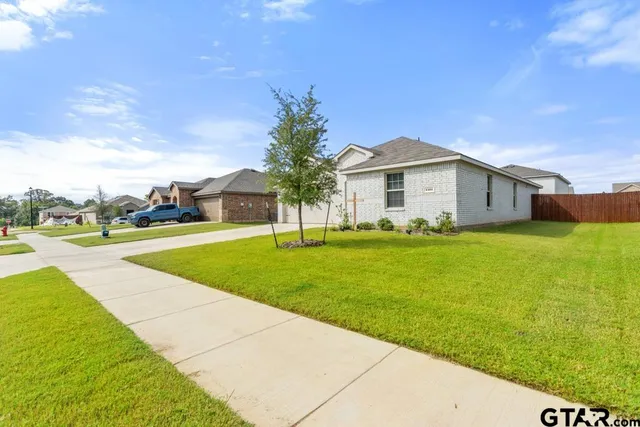 a view of an house with a garden and pathway