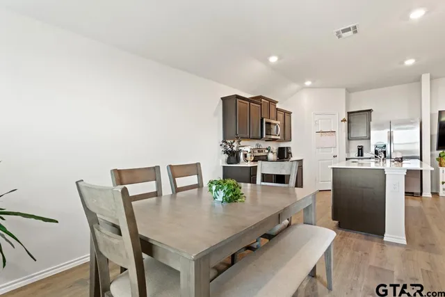 a view of kitchen with sink and refrigerator