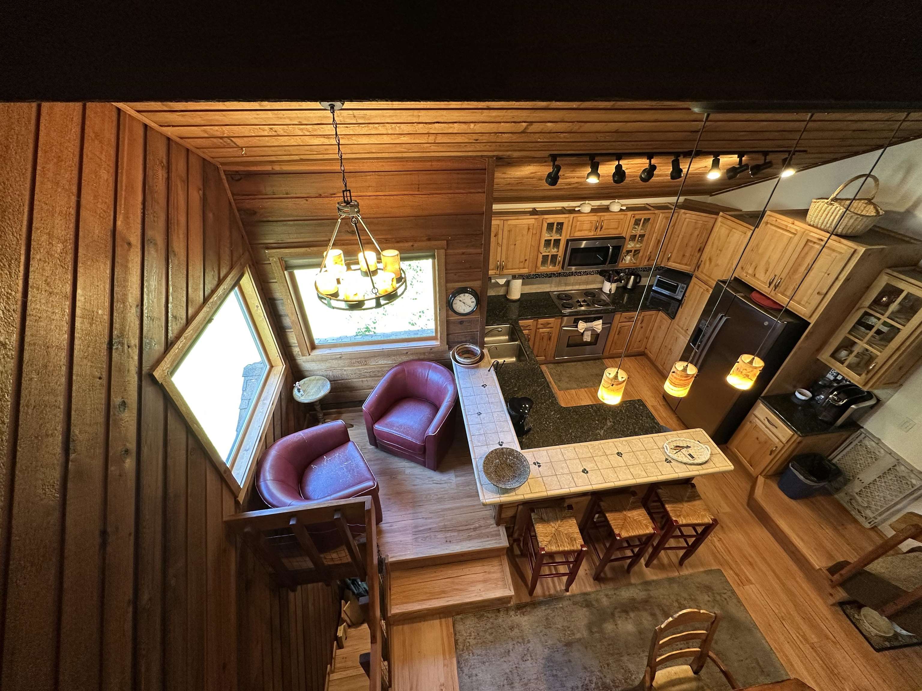 315 Fascination, Unit 315 Mammoth Lakes, CA 93546 - Photo 25 of 44 Open-concept living space with wood-paneled walls and a matching wood-finish ceiling
