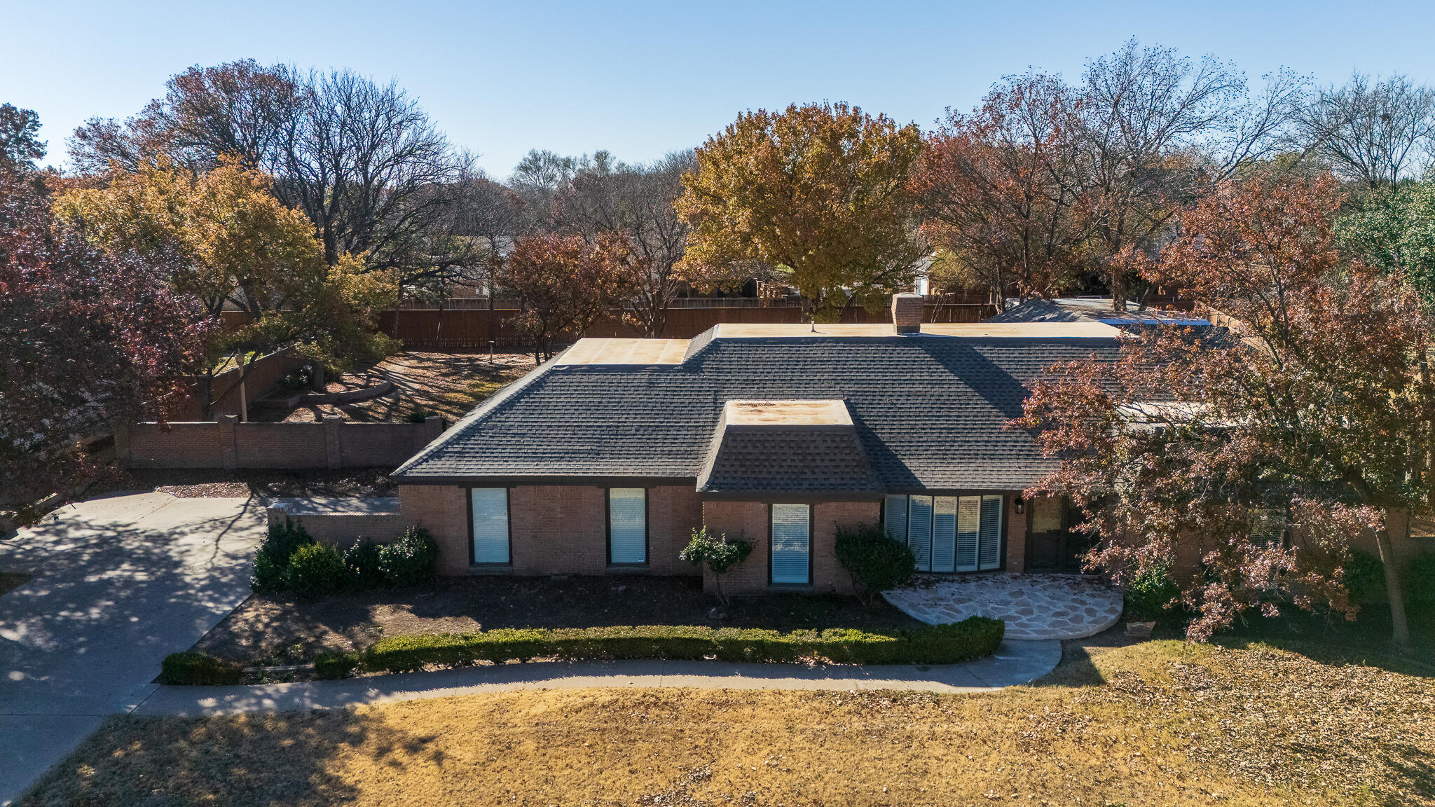 207 Yucca Terrace Plainview, TX 79072 - Photo 2 of 50 a front view of a house with a yard
