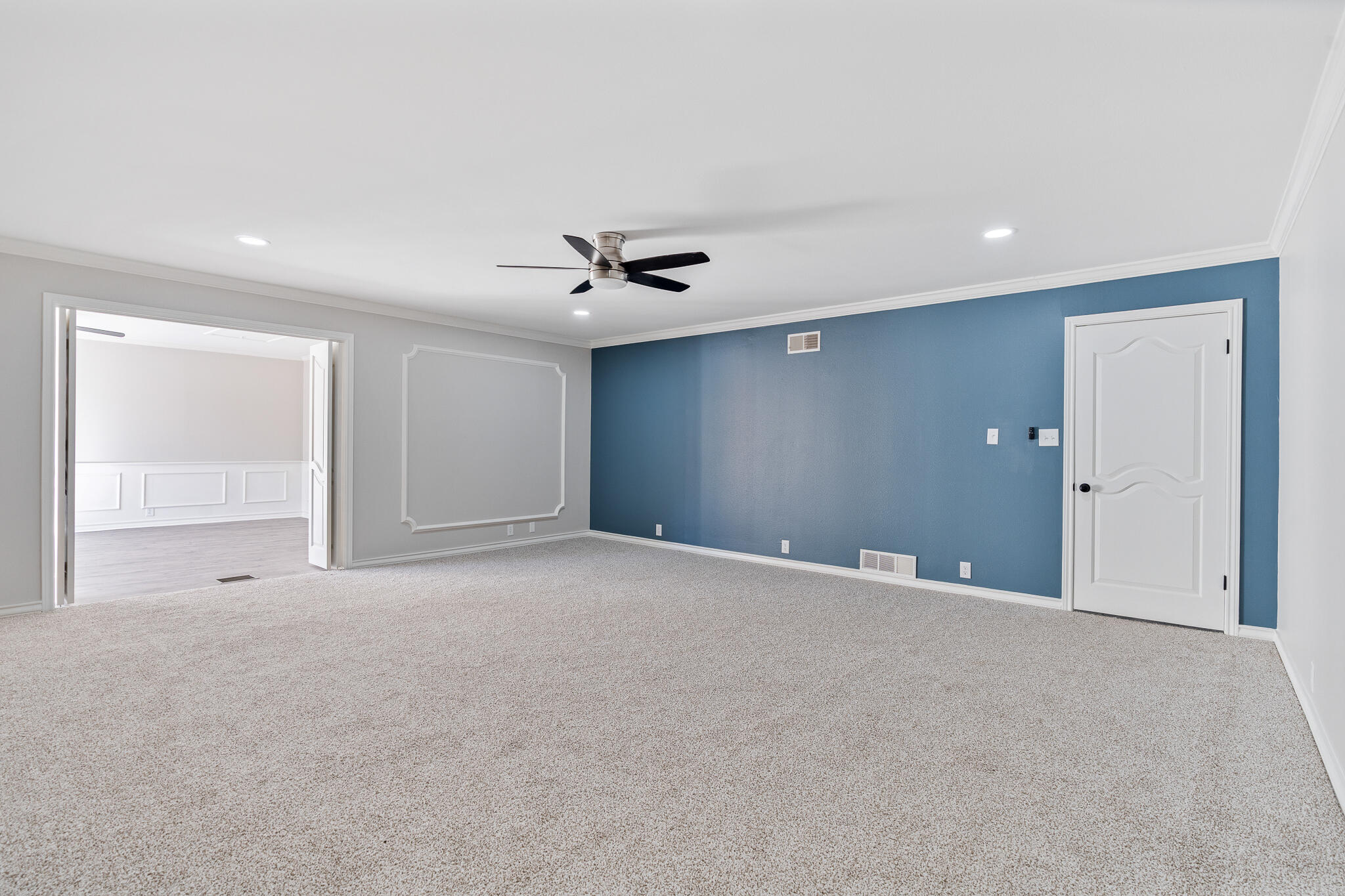 207 Yucca Terrace Plainview, TX 79072 - Photo 23 of 50 a view of an empty room with a chandelier fan