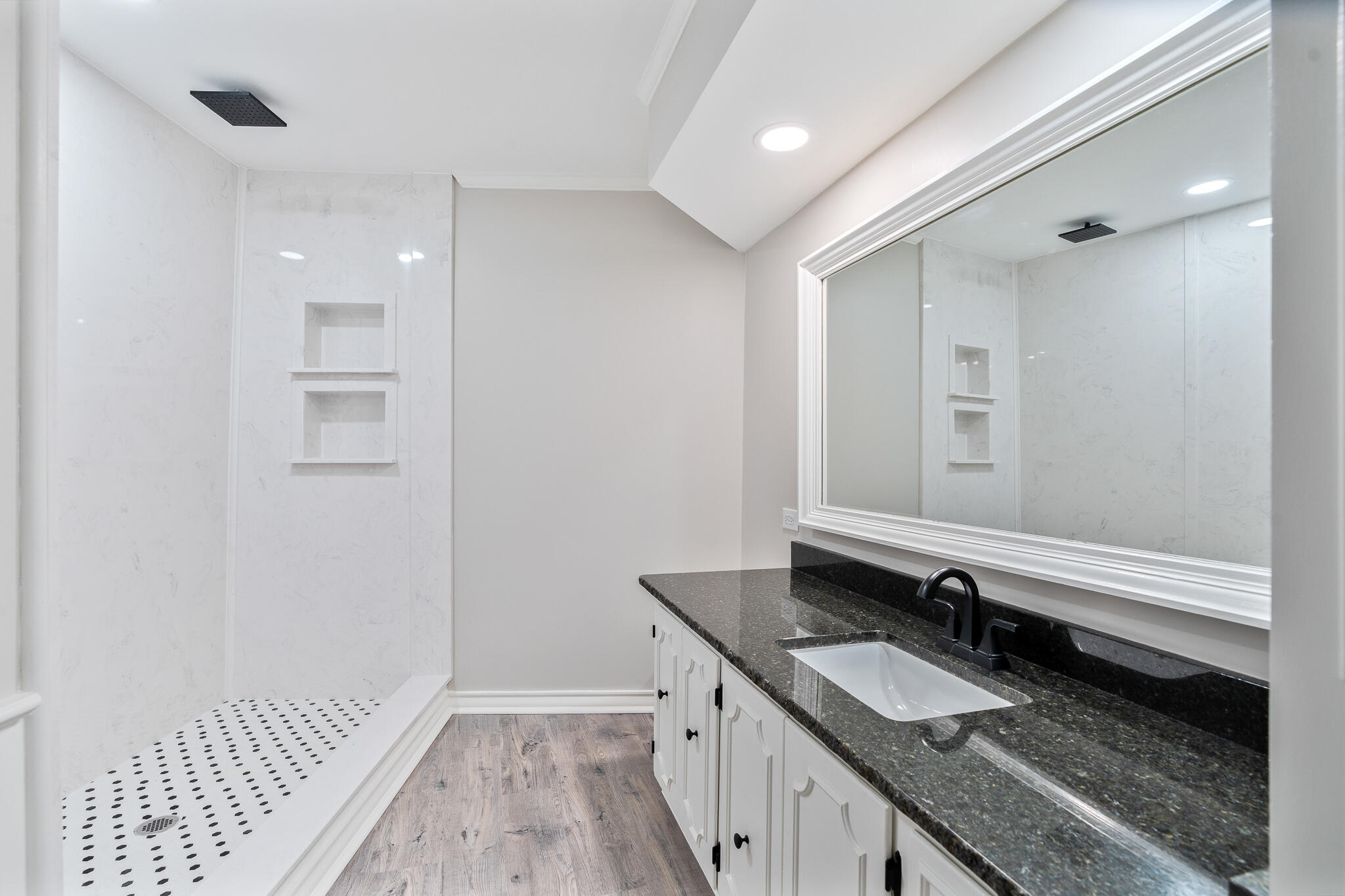 207 Yucca Terrace Plainview, TX 79072 - Photo 25 of 50 a bathroom with a granite countertop double vanity sink and a mirror