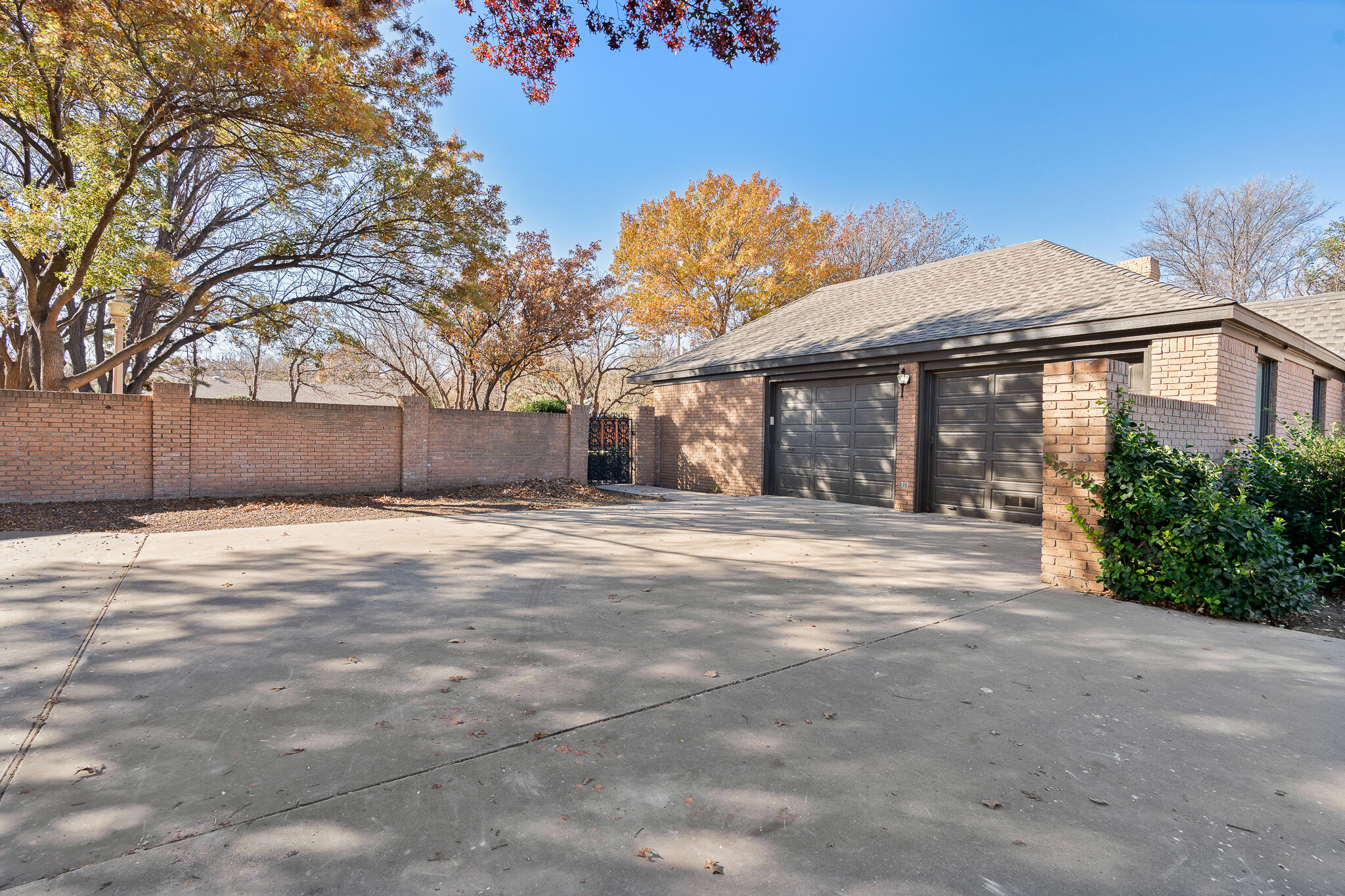 207 Yucca Terrace Plainview, TX 79072 - Photo 45 of 50 a front view of a house with a yard and garage