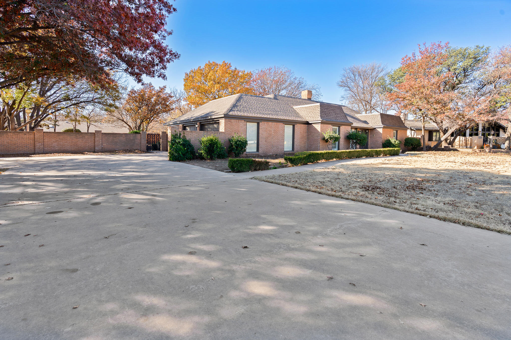 207 Yucca Terrace Plainview, TX 79072 - Photo 46 of 50 a front view of a house with a yard and a large tree