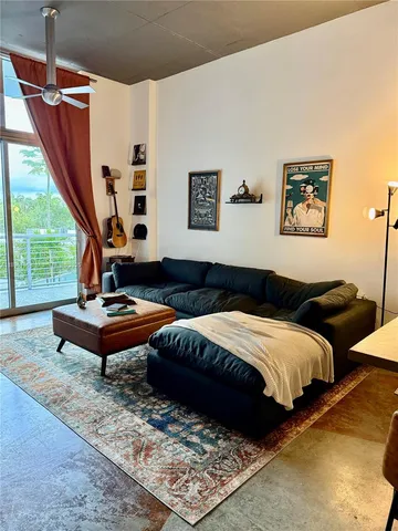 a living room with bed furniture and a window