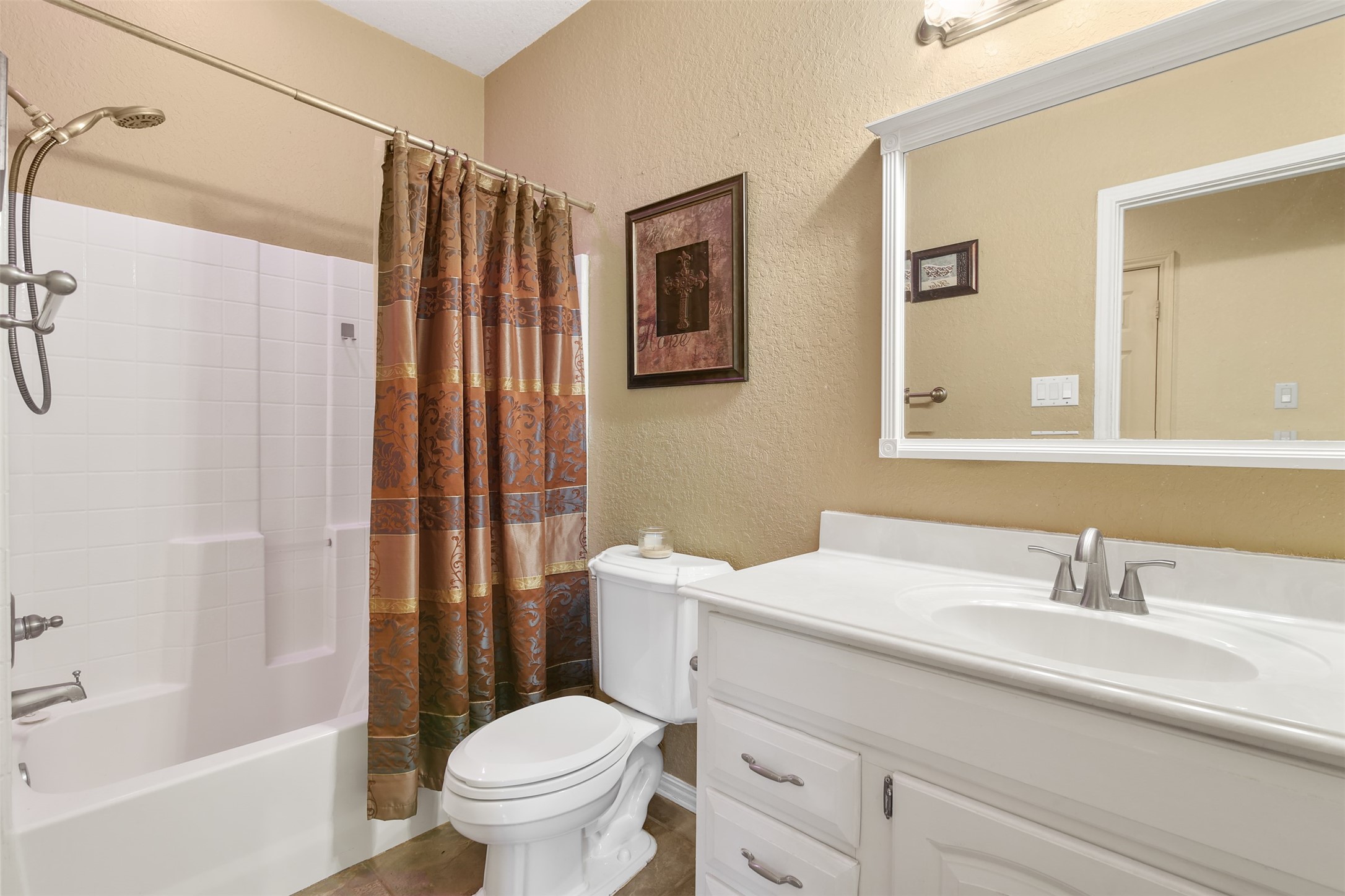 11692 Clark Lane Conroe, TX 77385 - Photo 16 of 35 Secondary full bathroom features a single sink vanity and tub/shower combo.