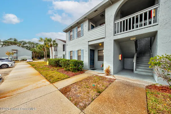 a view of a building with potted plants