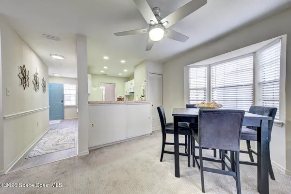 a view of a dining room with furniture and a chandelier