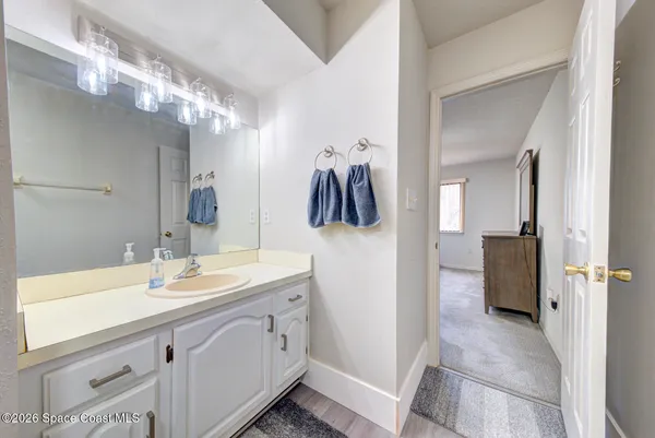 a spacious bathroom with a sink and a mirror