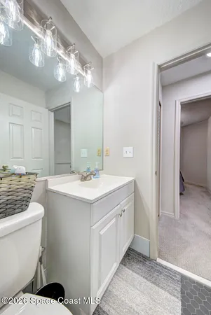 a bathroom with a sink a toilet and a mirror