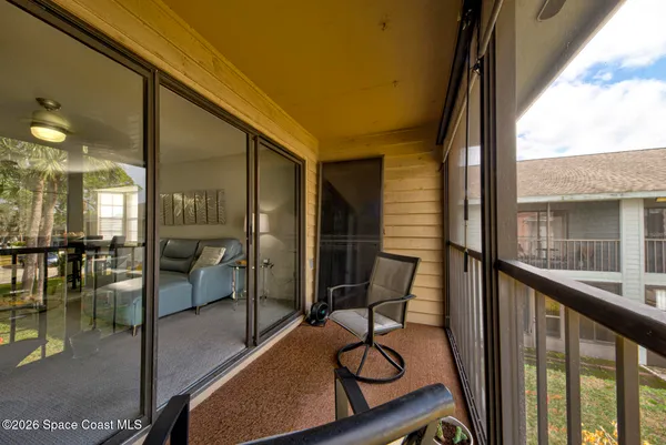 a view of a porch with chairs and backyard