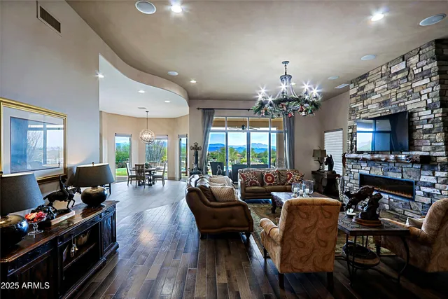 a living room with fireplace furniture and a chandelier