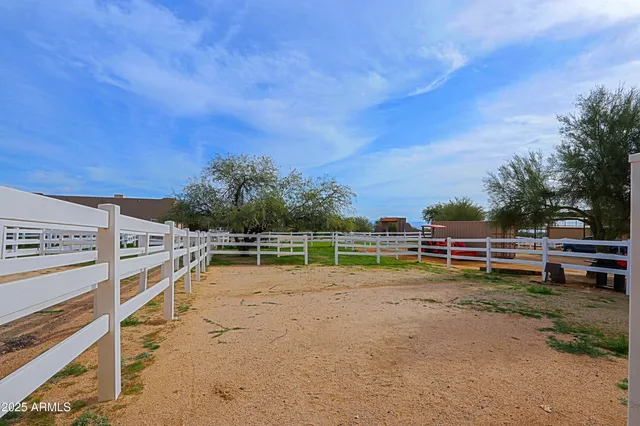 an aerial view of a house with a garden and lake view