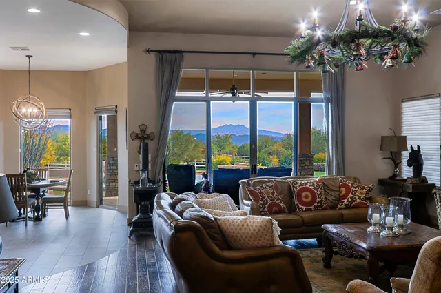 a living room with fireplace furniture and a chandelier