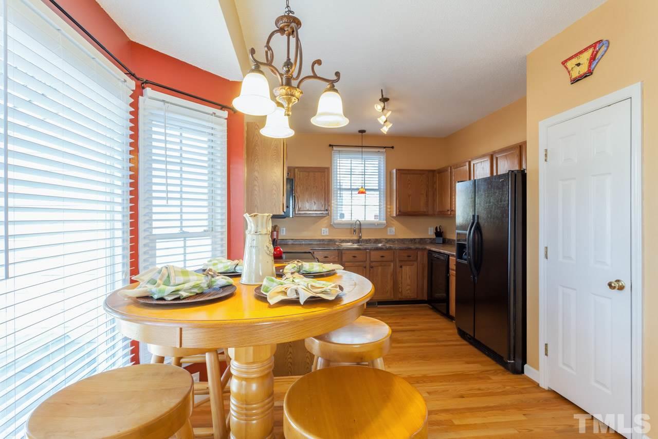 4601 Atterbury Court Raleigh, NC 27604 - Photo 11 of 25 a kitchen with a table and chairs in it