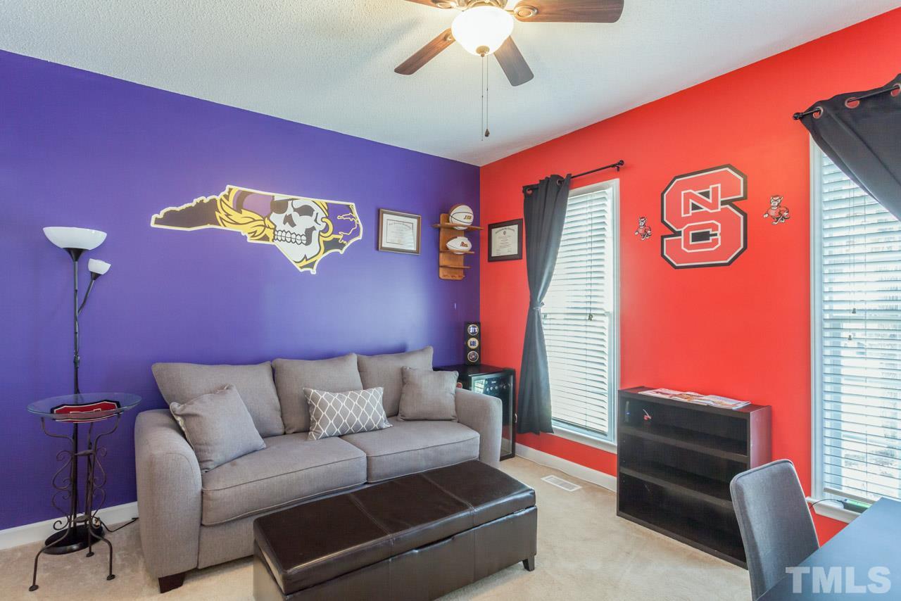 4601 Atterbury Court Raleigh, NC 27604 - Photo 15 of 25 a living room with furniture and a flat screen tv