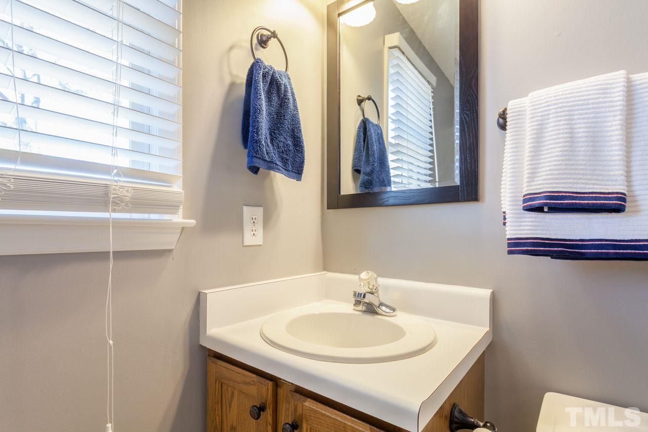 4601 Atterbury Court Raleigh, NC 27604 - Photo 17 of 25 a bathroom with a sink and a mirror