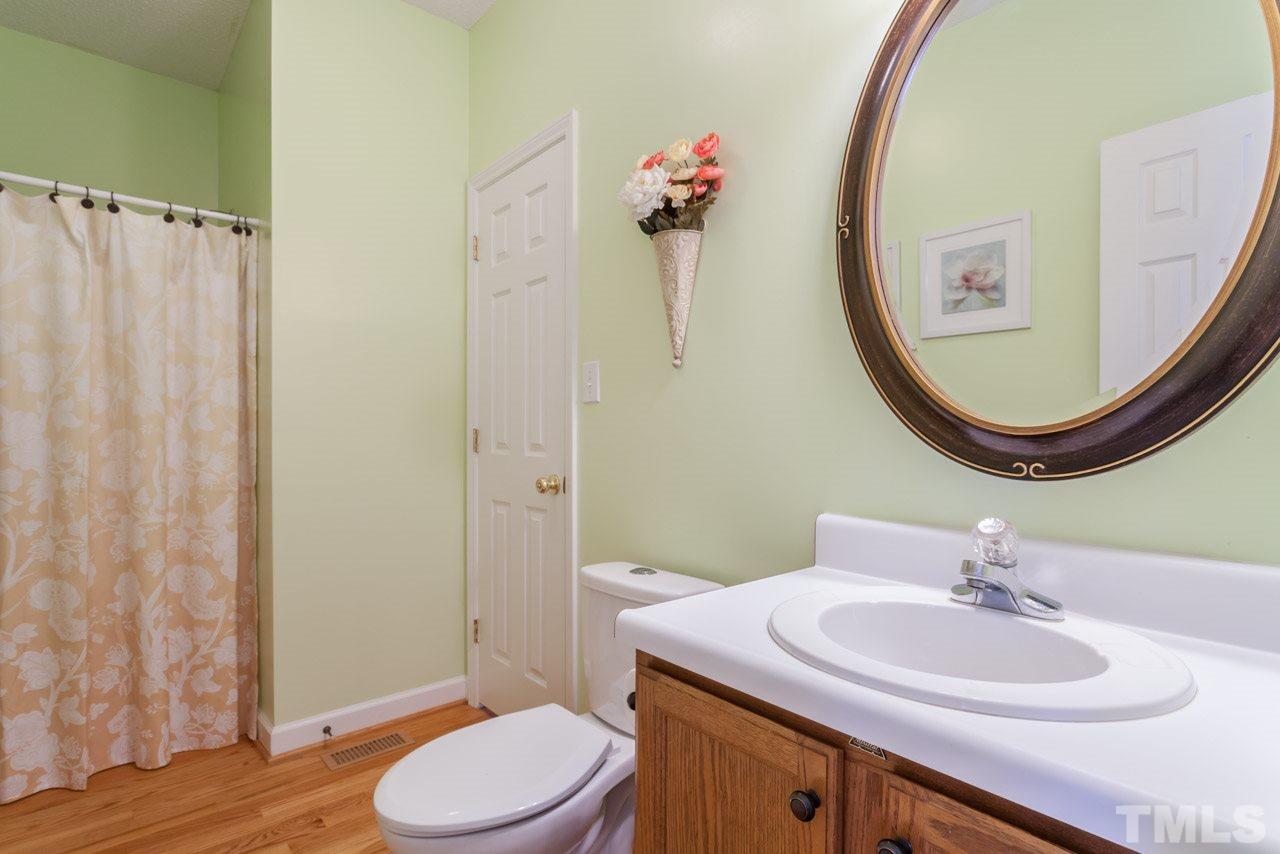4601 Atterbury Court Raleigh, NC 27604 - Photo 18 of 25 a bathroom with a sink vanity mirror and toilet